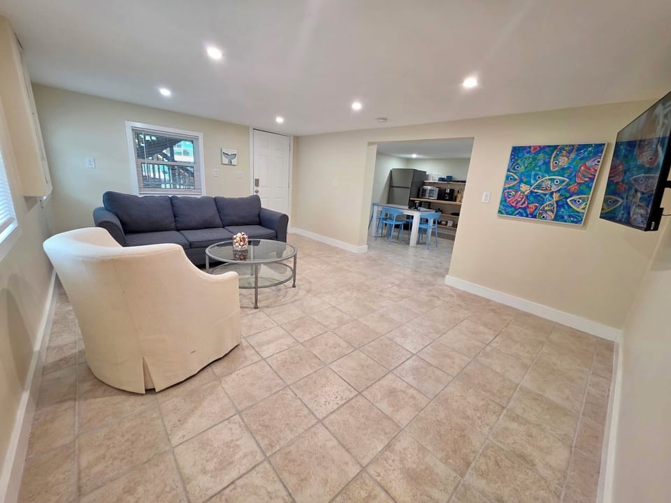 Comfortable living room offering cozy seating and a wall-mounted TV.