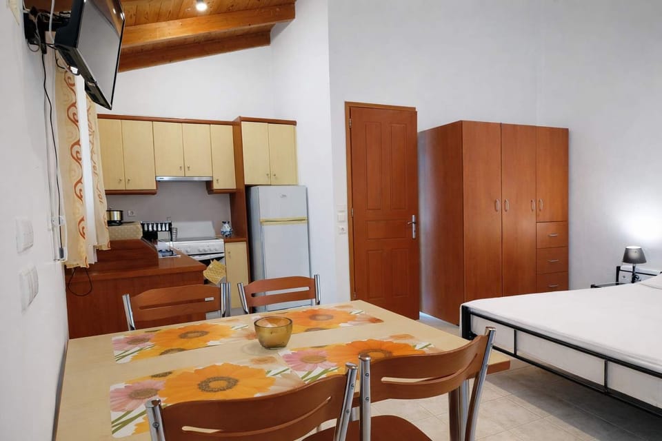 Cozy Kitchen & Dining Corner
Warm wooden finishes with compact dining space.