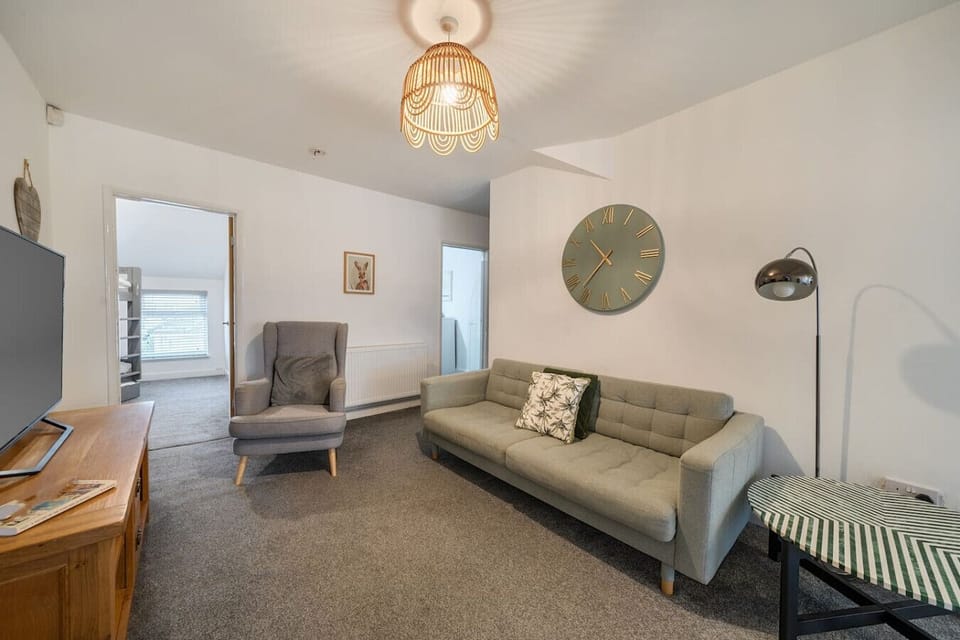 Living room seating area with sofa, armchair, and side table