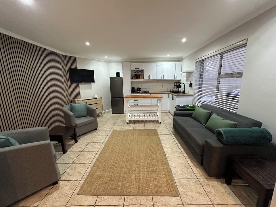 Open plan kitchen, tv area and double sofa bed