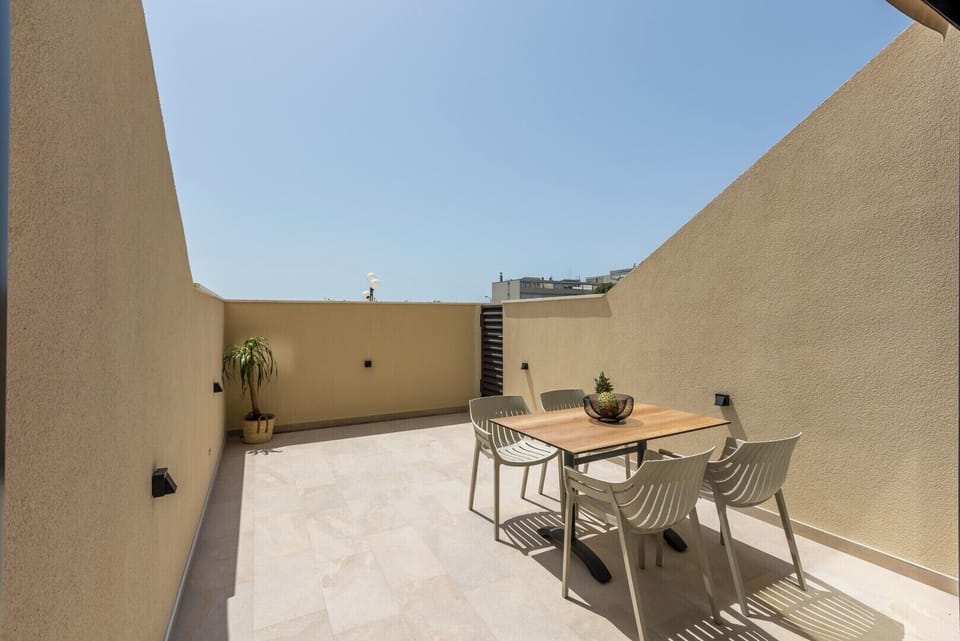 Large balcony with table and chairs, ideal for coffee or evening relaxing.
