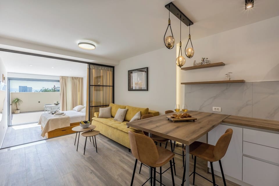 Living room with TV and plenty of natural light, bright and cozy space.
