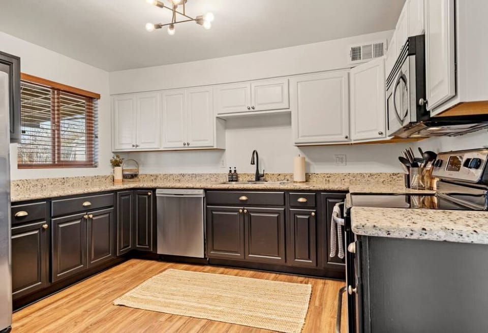 Full kitchen with dishwasher, electric range, and plenty of counter space.
