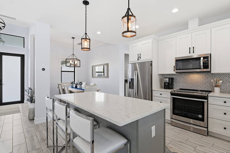Cookware, dinnerware, many kitchen tools and small appliances are provided, including a drip coffee maker.