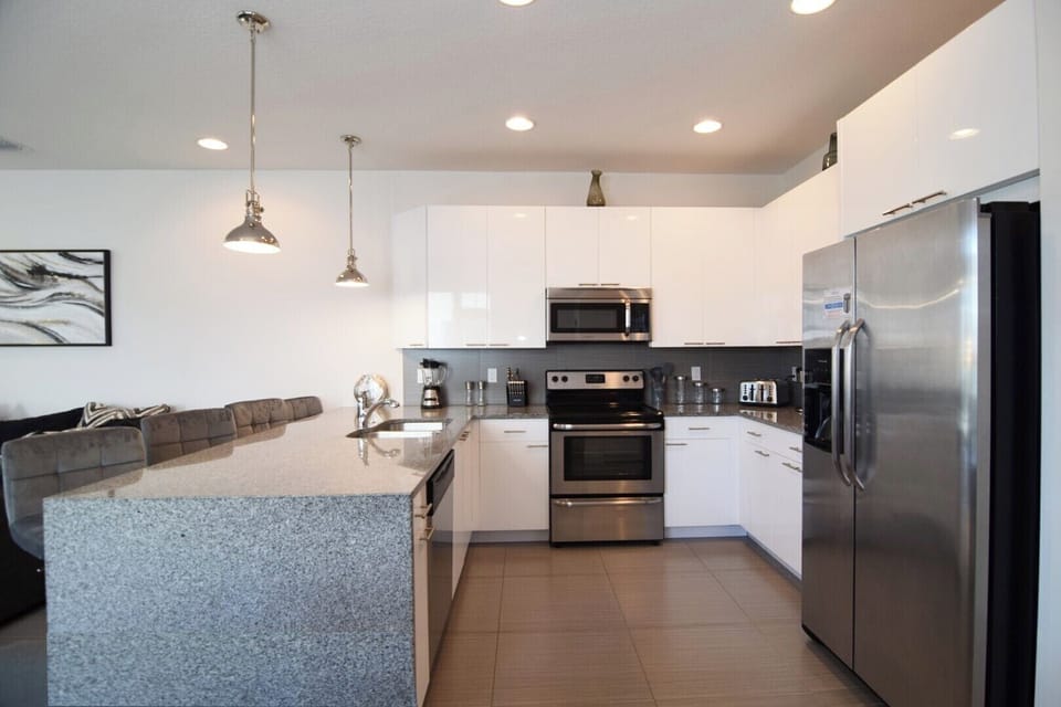 Fully-equipped kitchen with Stainless steel appliances & granite counters