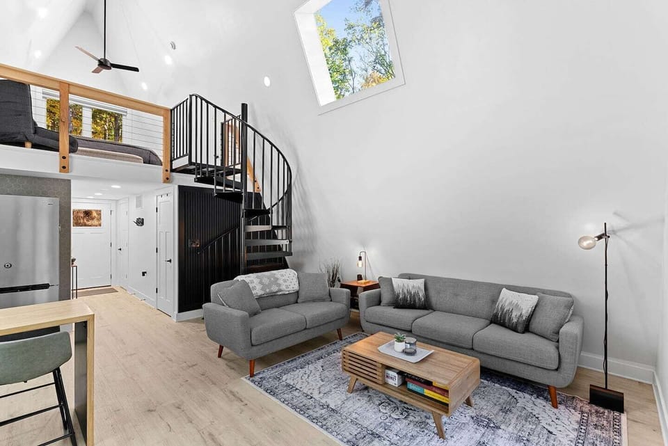 Spacious living room with board games, record player, and Bluetooth speaker.  