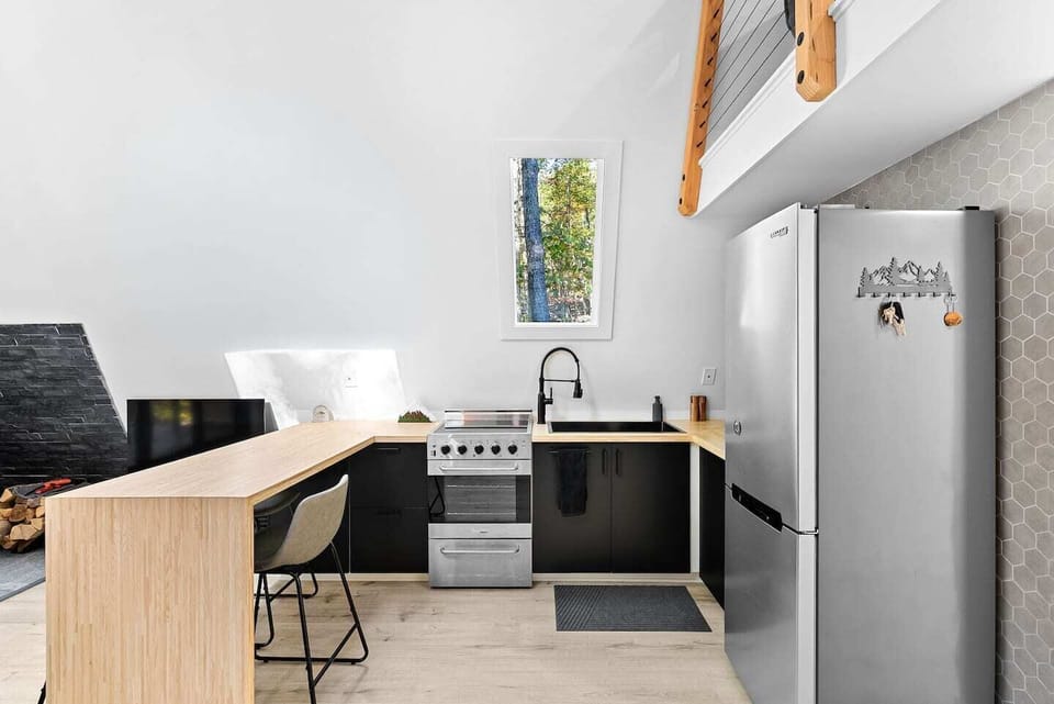 Kitchen features an electric range/oven, microwave, and toaster oven.  