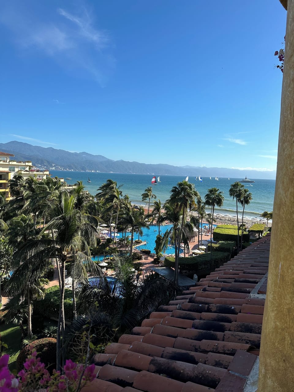 Looking down on pool and out to see and mountains