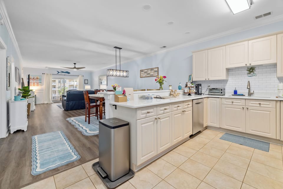 Kitchen leads directly into the dining and living room, with lots of natural sun