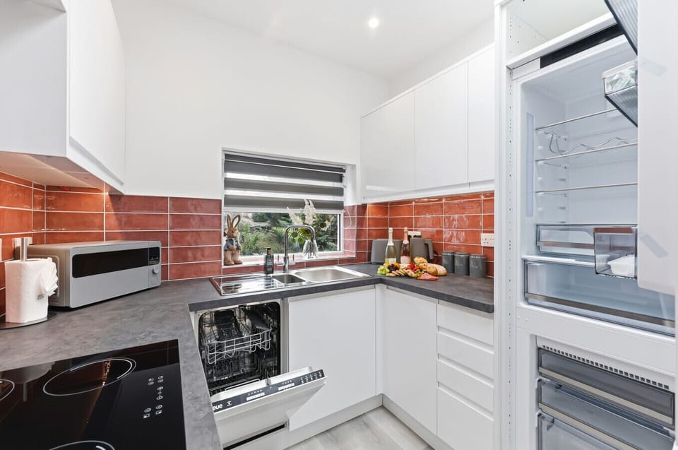 A fridge freezer and dishwasher are provided for your convenience.