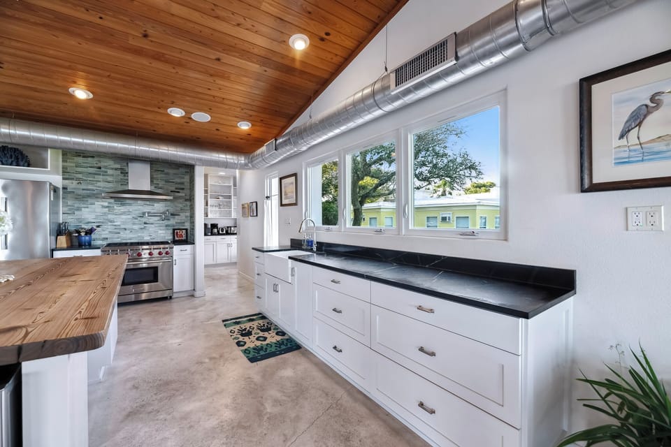 A farmhouse sink set beneath wide windows, bringing in natural light while offering a calm, functional space for everyday moments.
