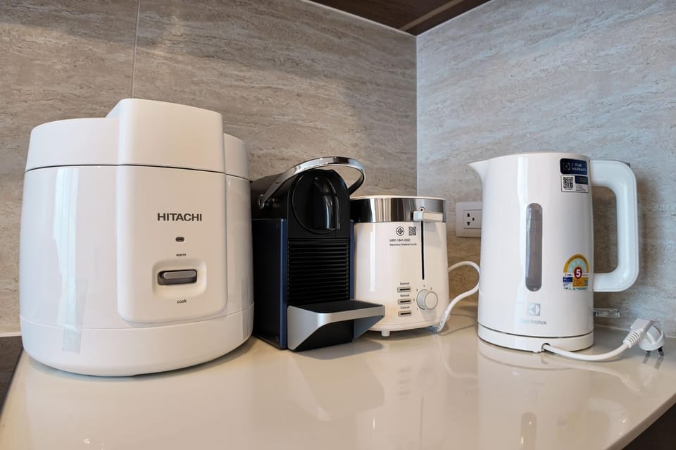 Convenient in-room setup with rice cooker, kConvenient in-room setup with rice cooker, kettle, coffee machine, and essential appliances.ettle, coffee machine, and essential appliances.