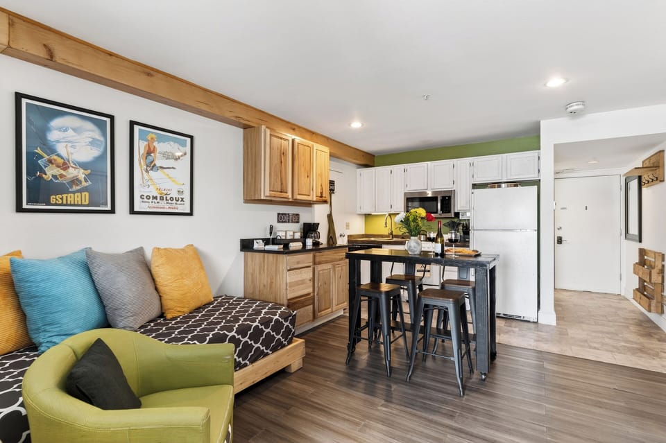 Studio space featuring a daybed and a modern kitchen island.