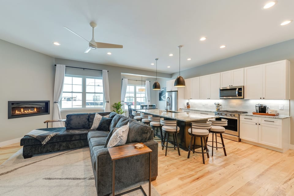 The spacious open-concept living area with cozy seating and seamless flow leads straight to the dining room and kitchen.