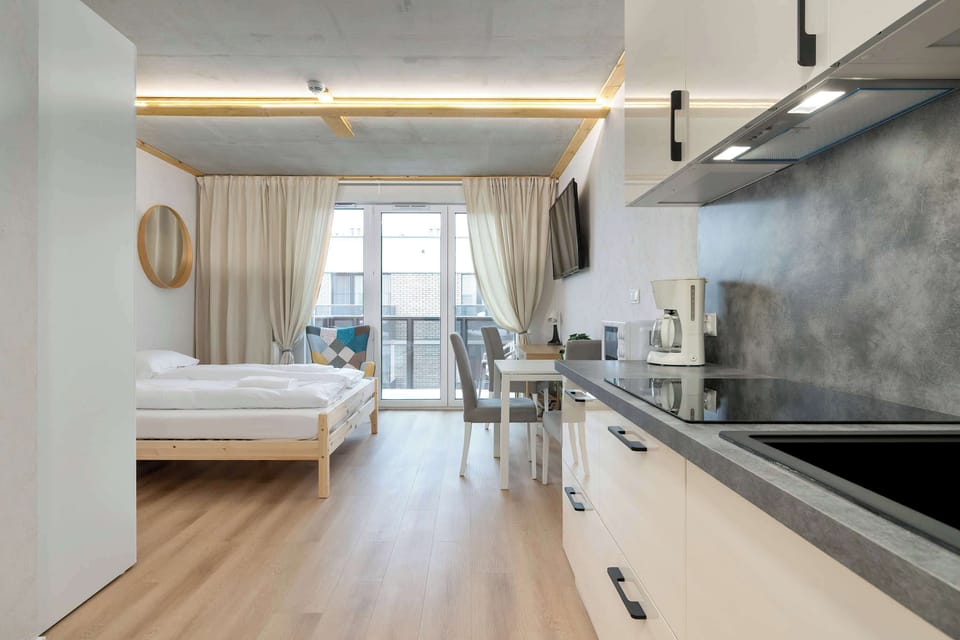Kitchenette and studio view towards balcony.
