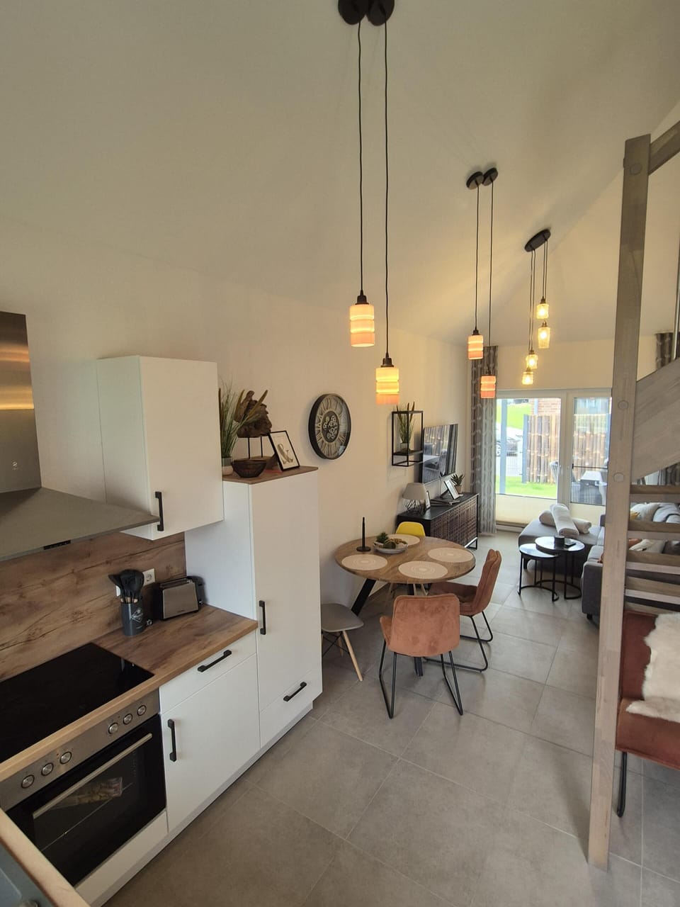 Modern kitchen with dining table and living area.