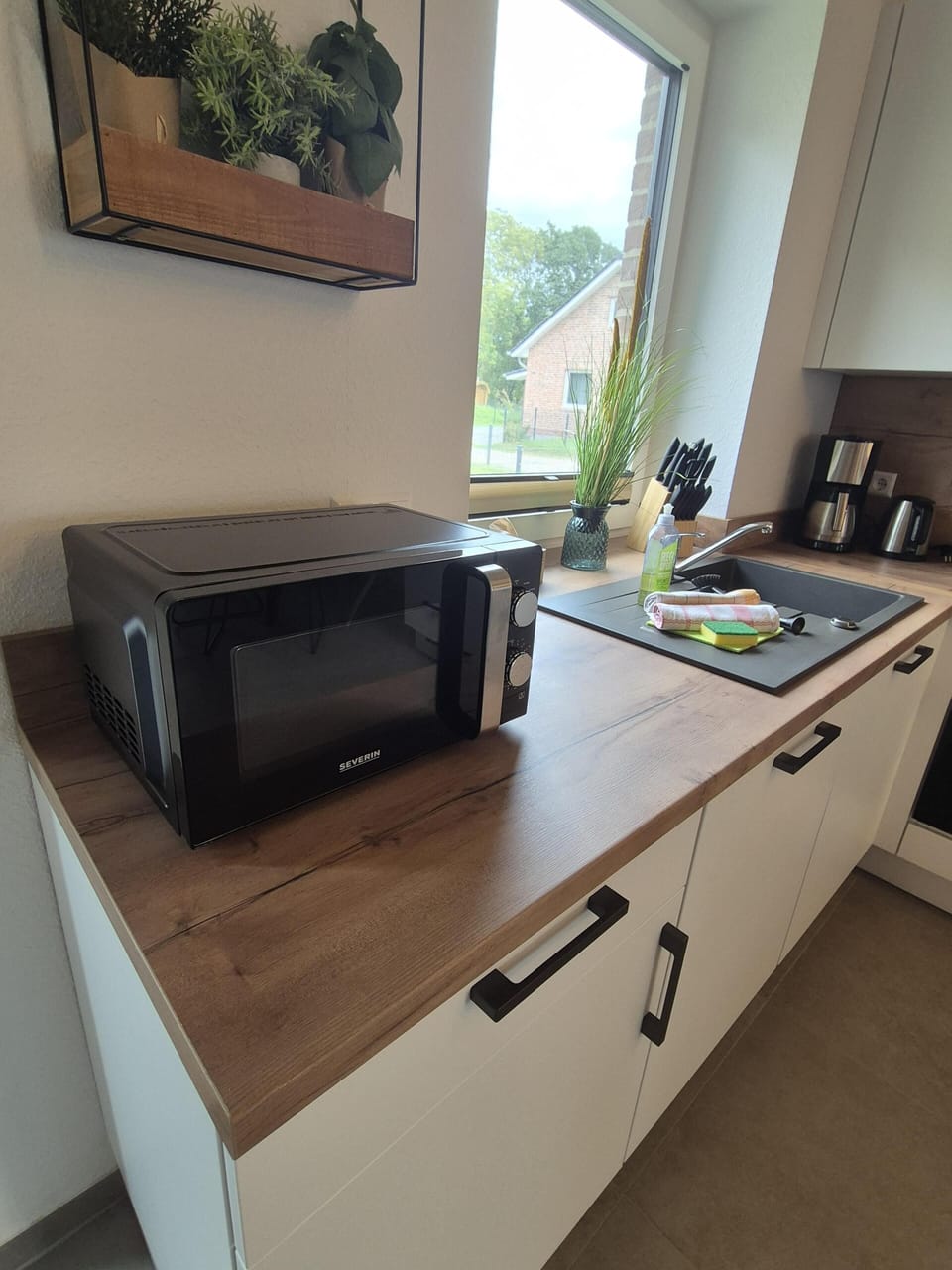 Modern kitchen with microwave and sink.