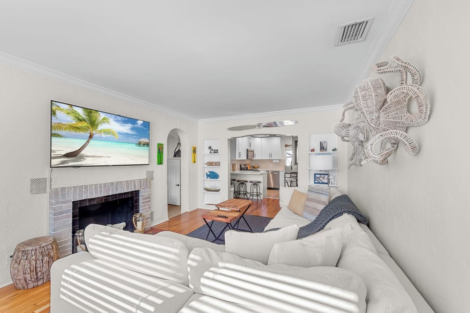 Living Room: Relax in style with beachy decor and a grand TV featuring tropical views!