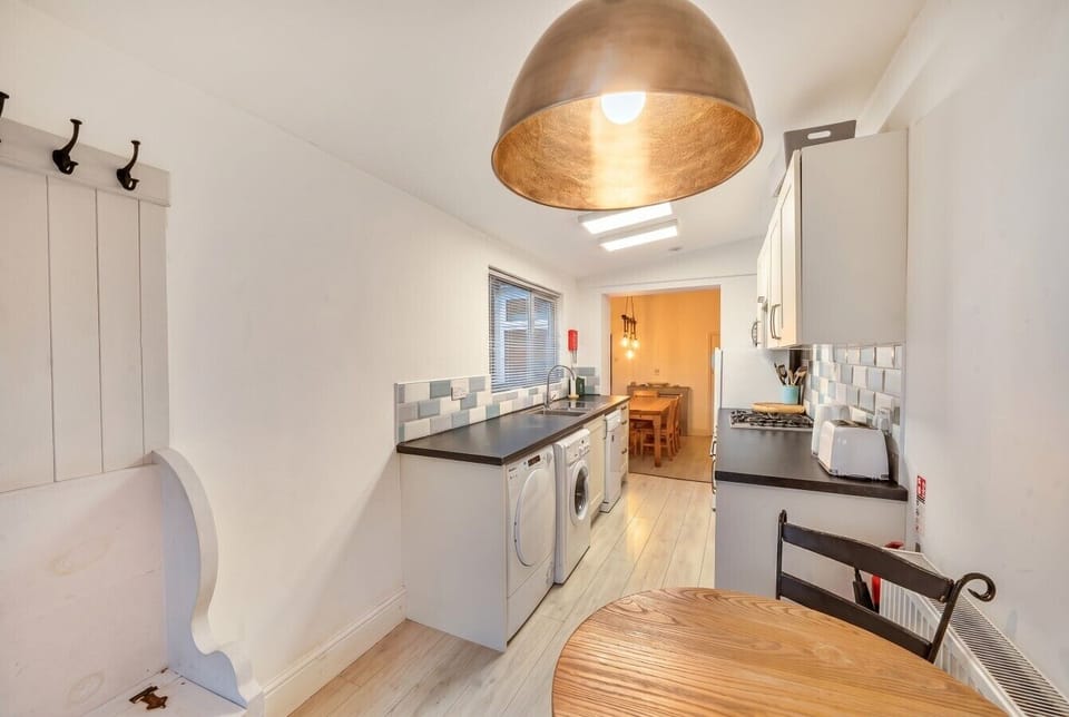 Well-equipped kitchen flowing through to the bright dining area beyond.