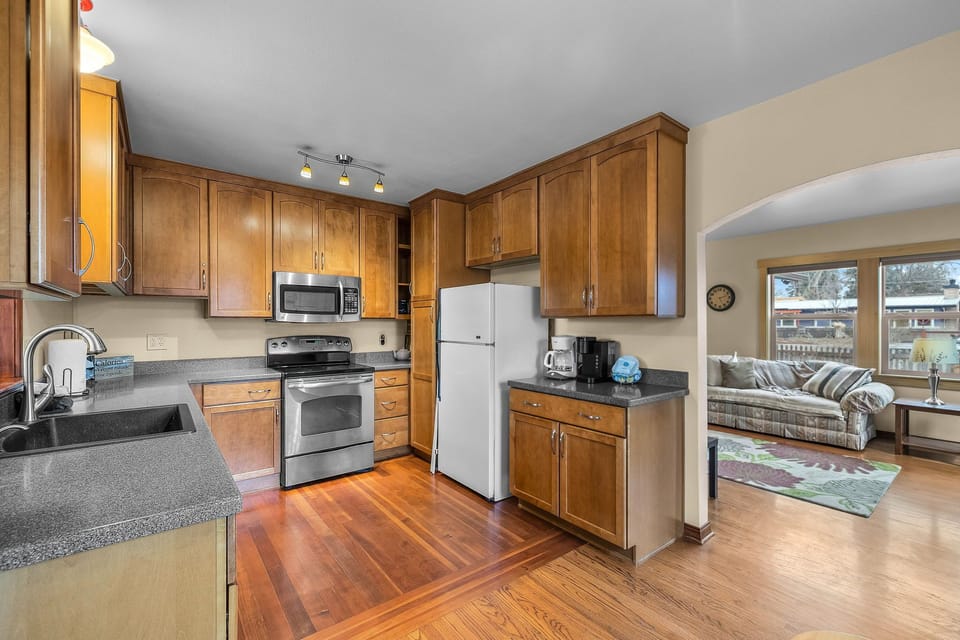 Your fully equipped kitchen features warm wood cabinets, granite counters, and stainless appliances - perfect for preparing memorable meals together.
