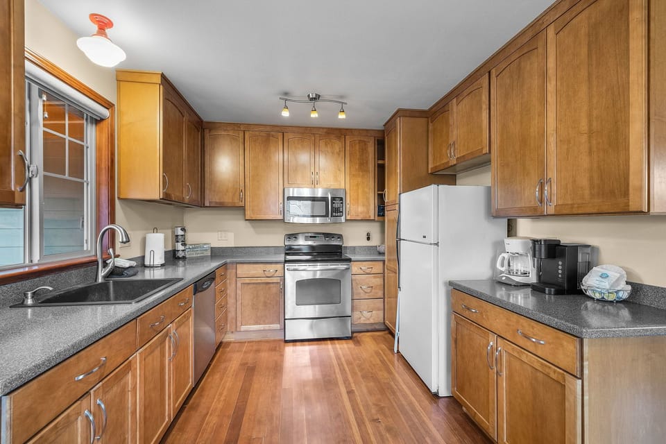 Your spacious kitchen features rich wood cabinets, granite counters, and stainless steel appliances for memorable meal preparation.