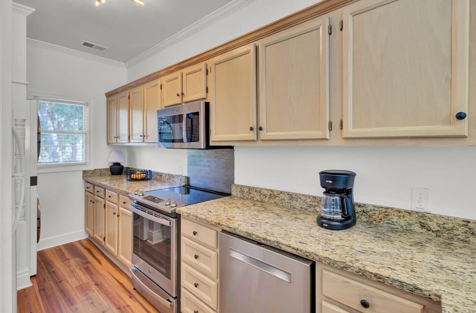 Step into your fully-equipped kitchen where granite counters and stainless appliances await your culinary adventures.