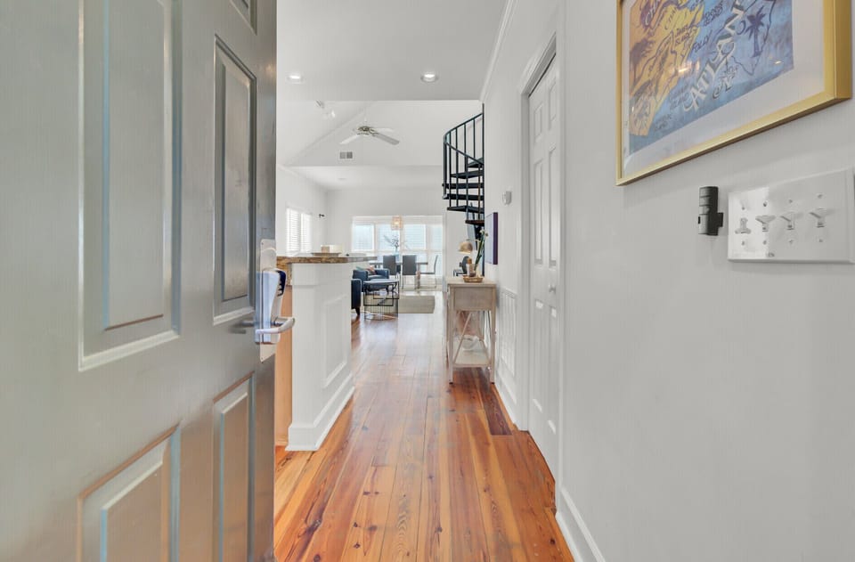 Step into your stylish retreat where warm hardwood floors flow through bright, open spaces adorned with coastal artwork and modern touches.