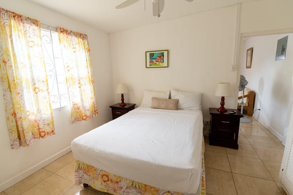 Unwind in a bright bedroom with crisp linens.
