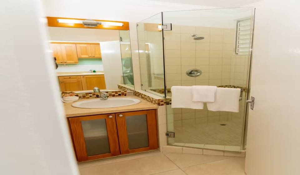 Refresh after the beach with a bright, glass-walled shower.