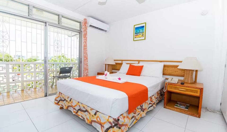 Wake up refreshed beside the balcony, sunlight, and cool AC.