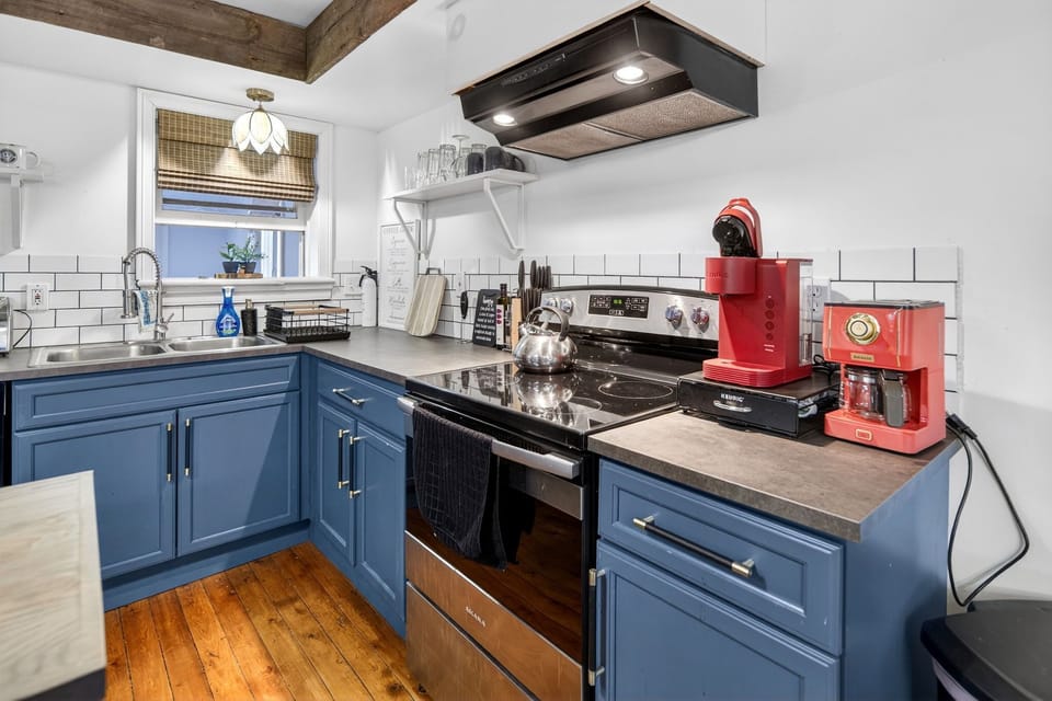 Coffee bar with Keurig, drip maker, and kettle for your morning caffeine fix.