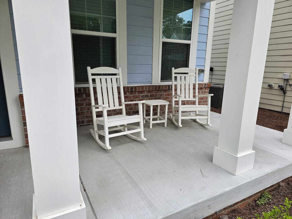 Outdoor furniture on front porch.