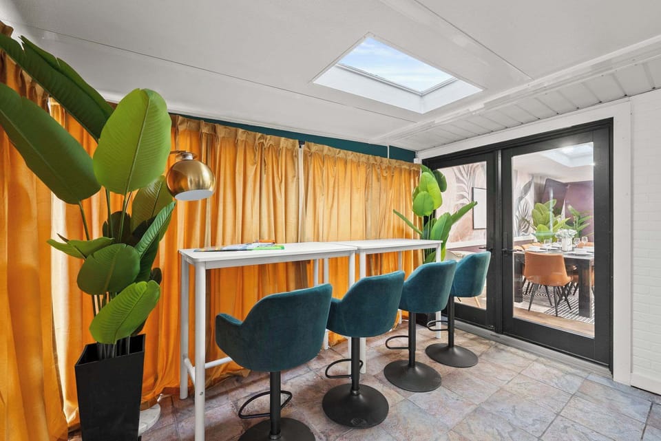 Bright game area w/ bar seating & large windows bringing in natural light.