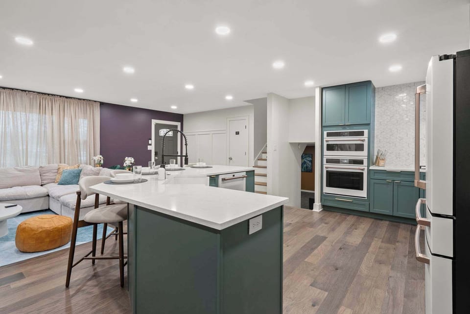 Contemporary kitchen w/ expansive island, modern lighting & plenty of prep space.