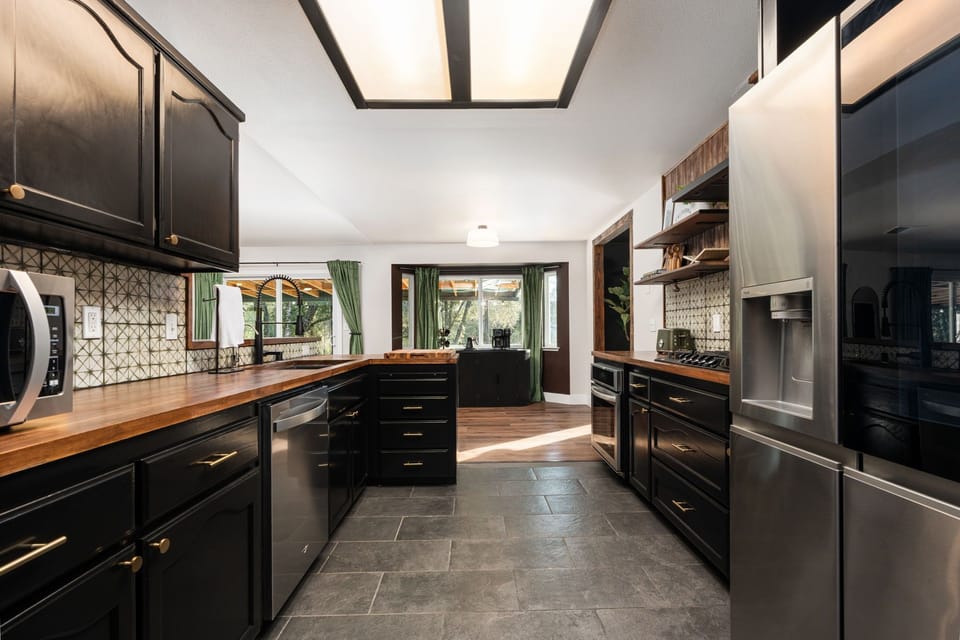 Cook together in style. Spacious counters, sleek appliances, and warm textures throughout.
