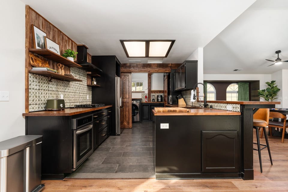 A beautiful, functional kitchen with warm wood accents and plentiful counter space for easy meal prep.