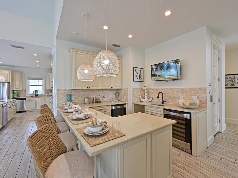 Entertaining bar area with Barstools, wine, fridge, mini fridge, etc.