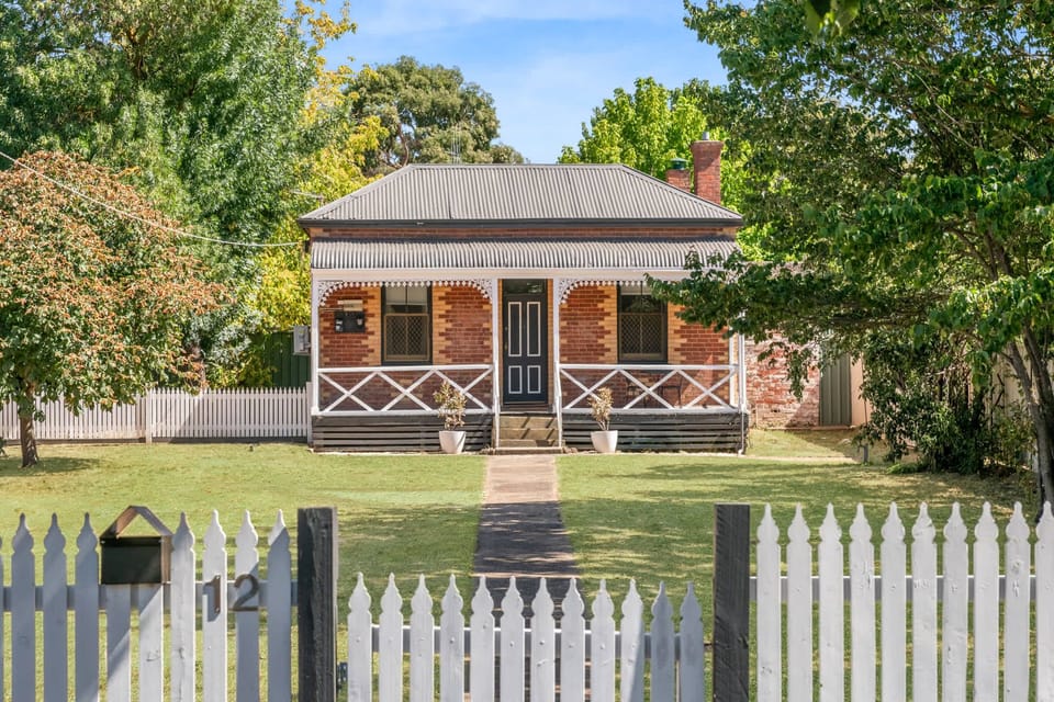 Large Front Yard Behind a White Picket Fence