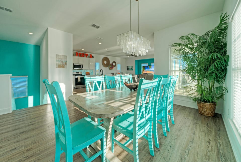 Bright, coastal dining space with seating for the whole group—perfect for family meals, game nights, and gathering after a day at the beach.