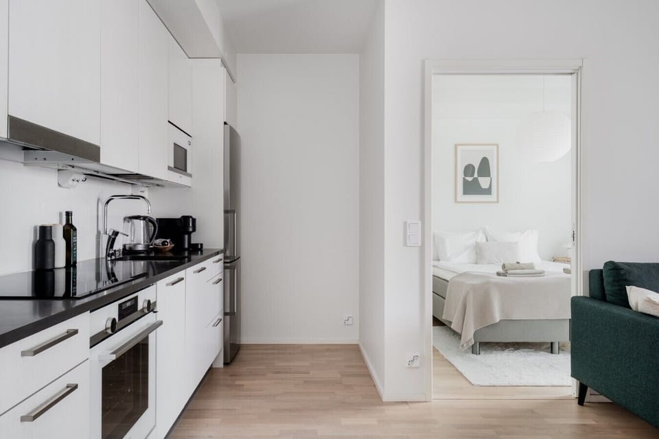 The bright and spacious apartment features a separate bedroom with a sliding door that can be closed when needed, ensuring a peaceful atmosphere and added privacy.