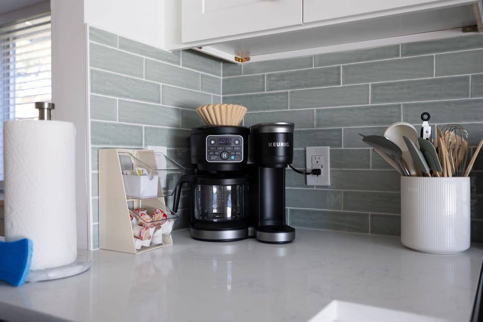 Mornings start better at Pickleball Point ☕️ A fully stocked coffee bar, coastal tile backsplash, and bright quartz counters