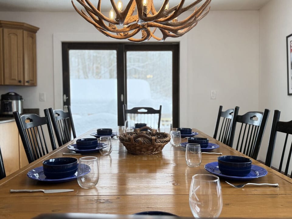 Gather the whole group around our large wooden dining table, set beneath a striking antler chandelier.