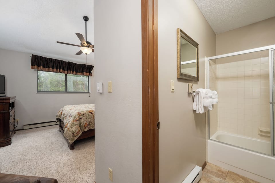 Your comfortable bedroom features a cozy bed and private bathroom with fresh towels waiting for you.