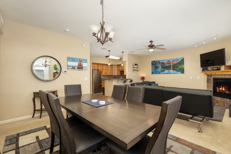 Gather around the elegant dining table while the fireplace crackles nearby, creating perfect moments for shared meals and conversation.