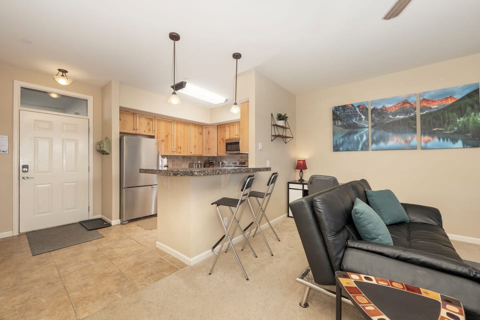 Unwind in your stylish open-concept space with a fully equipped kitchen and comfortable seating area perfect for relaxing after mountain adventures.
