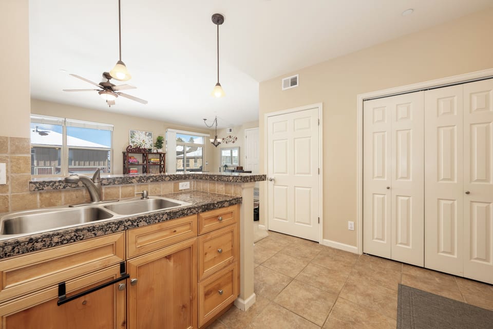 Your fully equipped kitchen features granite counters, double sink, and warm wood cabinets—perfect for preparing memorable meals during your stay.