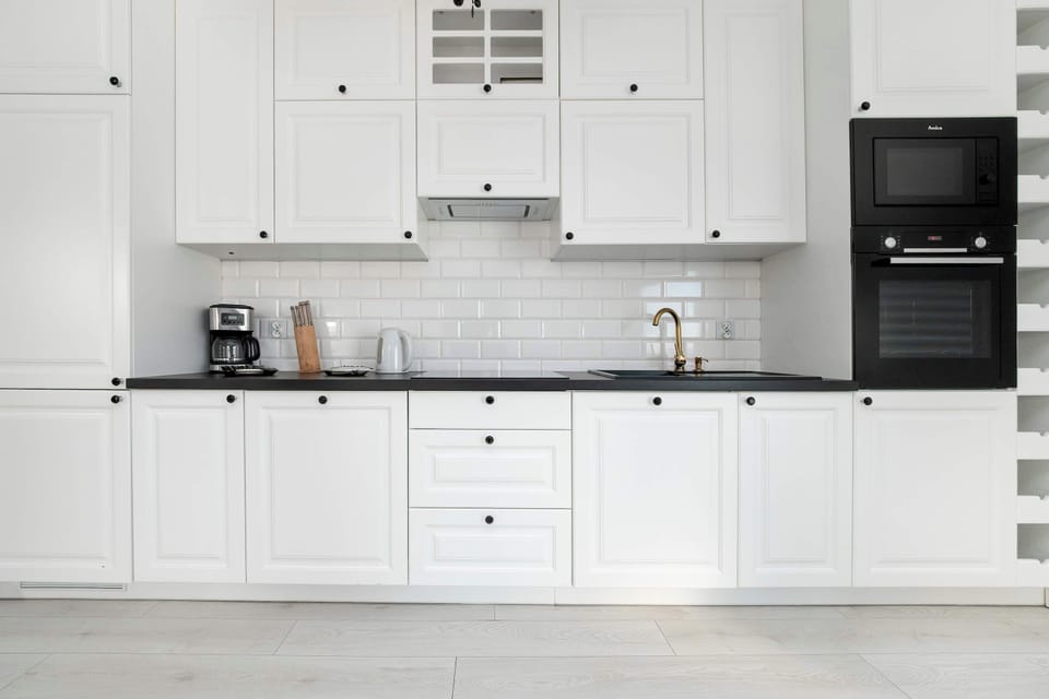 The sleek design of the kitchenette blending seamlessly with the living area.