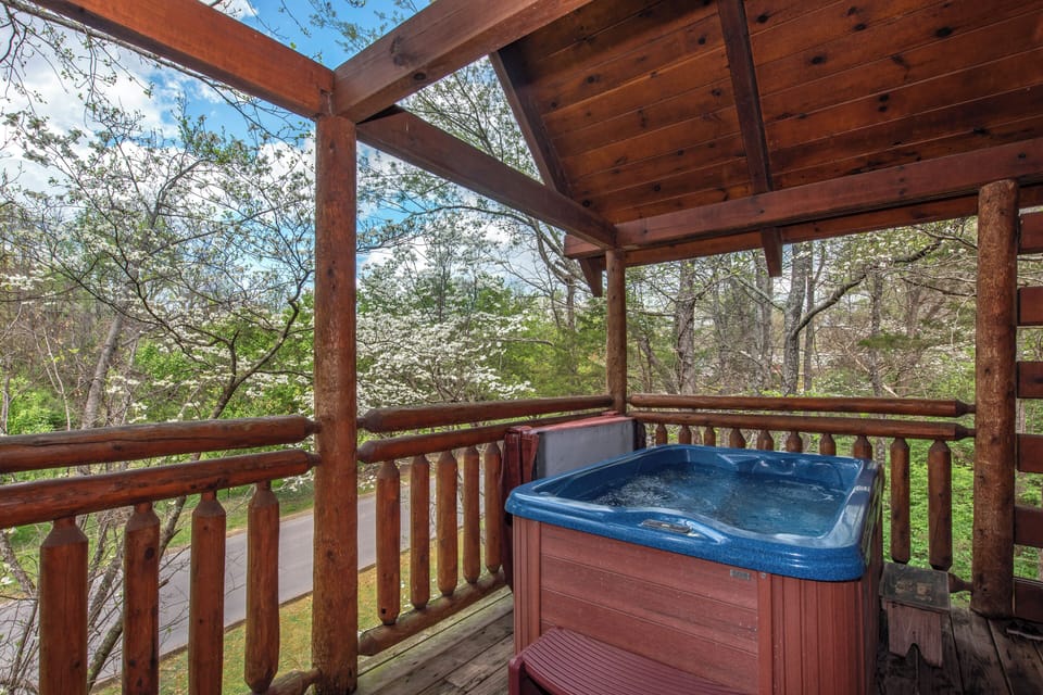Soak in your private hot tub while surrounded by blooming dogwood trees and peaceful forest views on the covered deck.