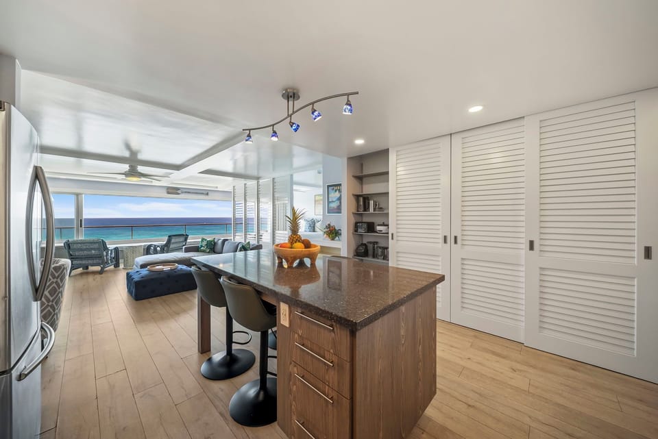 You'll love cooking in this modern kitchen while gazing at stunning ocean views through the open panoramic windows.
