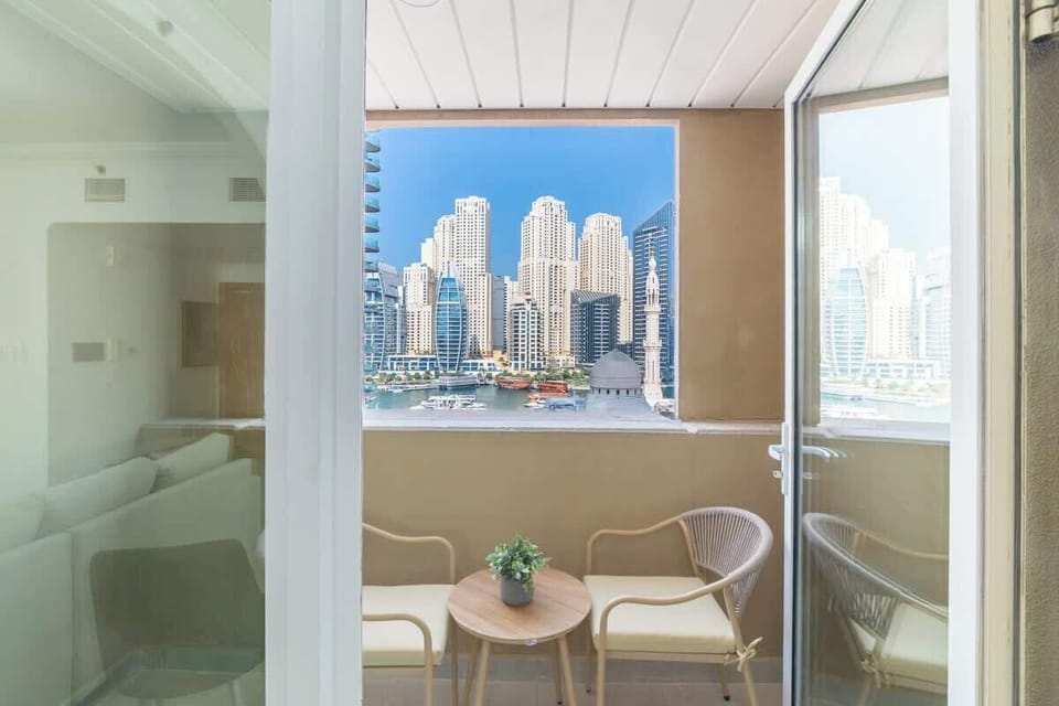 Step out onto the cozy balcony with stylish seating, offering breathtaking views of the marina skyline and vibrant city life—a peaceful escape amidst the urban charm.